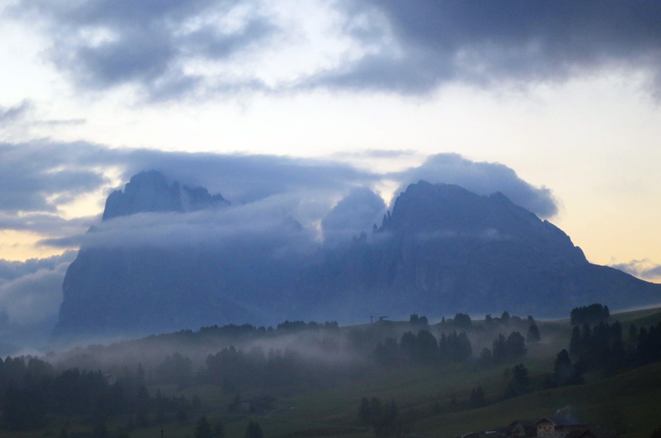 sunrise with clouds over the Plattkofel mountains in Dolomites Italy