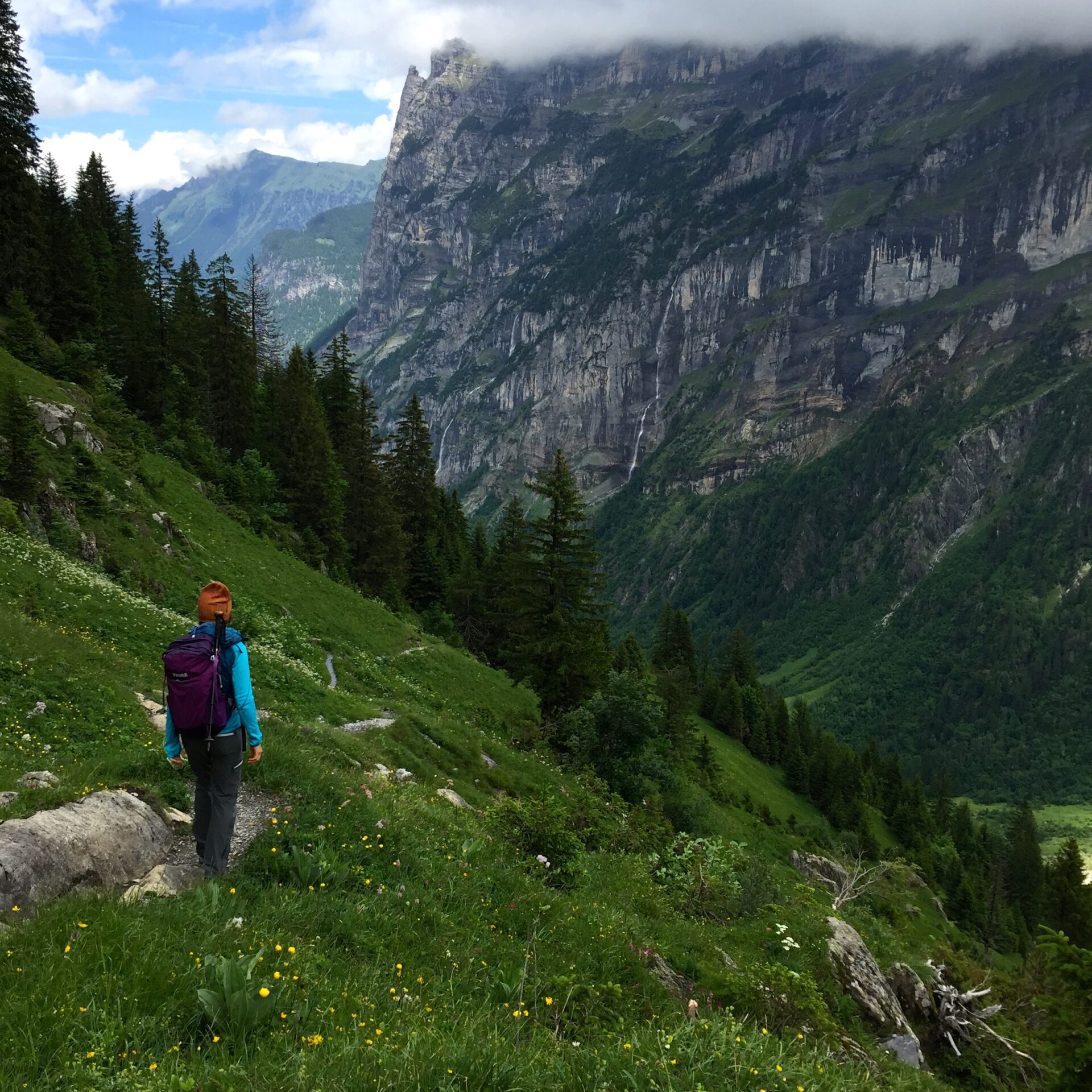 hiker on trail in Lauterbrunnen Valley, Switzerland, Swiss Alps