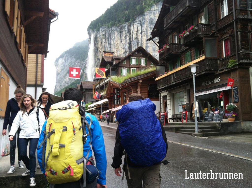 hikers with backpacks in Lauterbrunnen, Switzerland