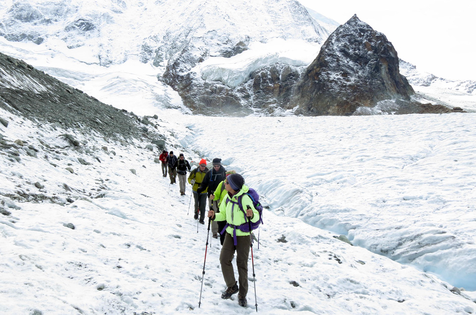 hikers on snowy trail Haute Route Alps