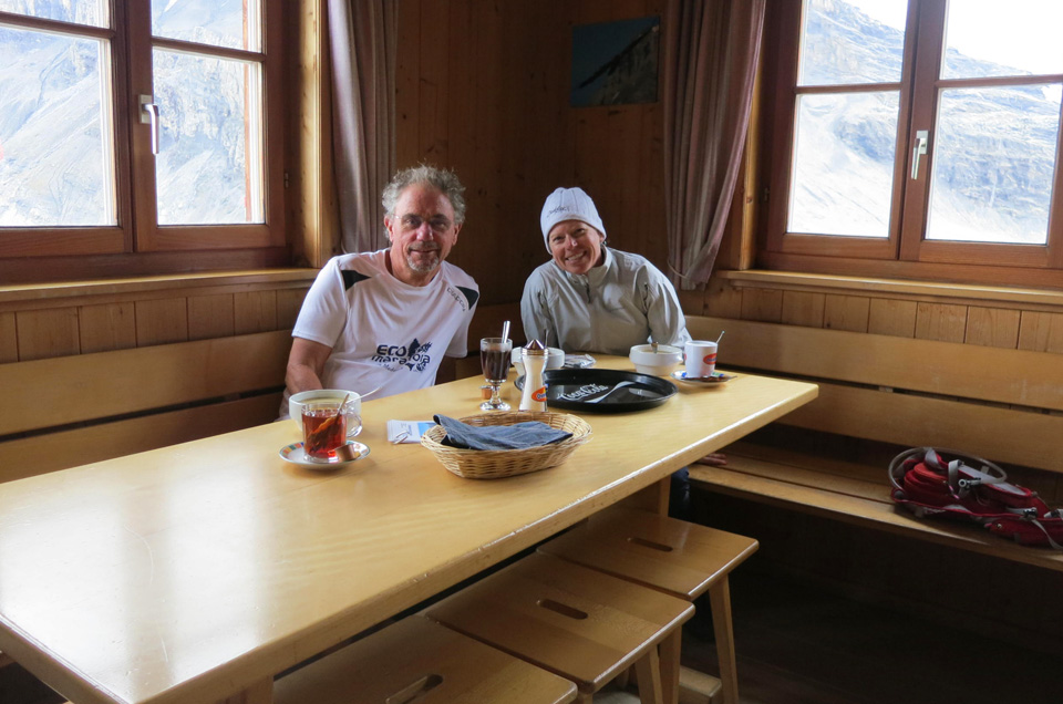 interior view of happy hikers snacking at Lämmeren hut, Swiss Alps