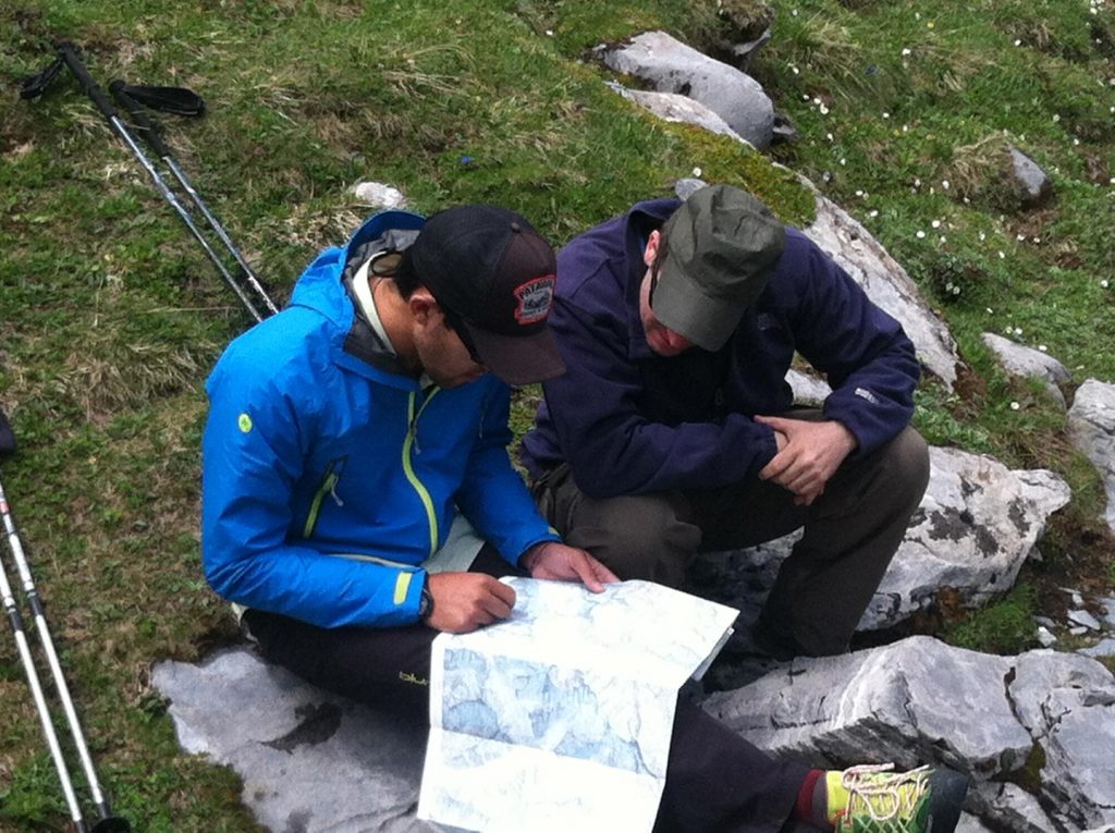 hiker and guide looking at a trail map for route from Oberhornsee to Murren, Switzerland