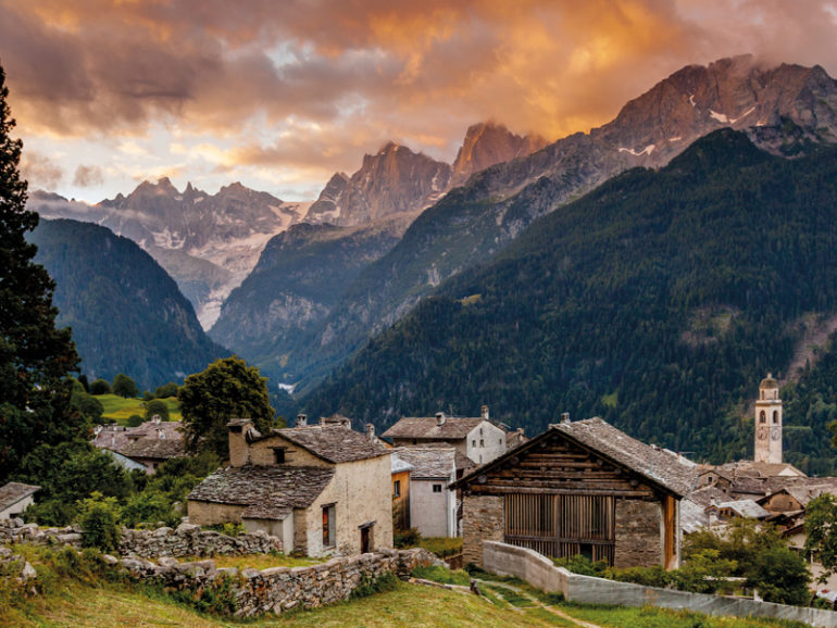 The sun rising over the mountains beyond Soglio, in the Val Bregaglia just south of the Engadine region.