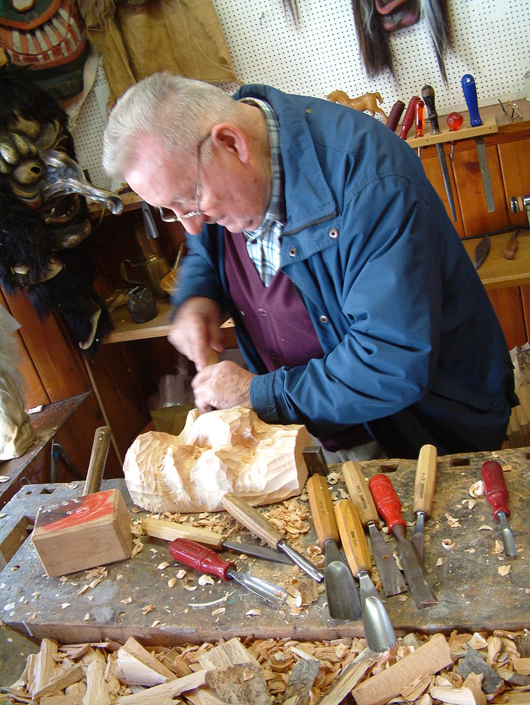 carving a wooden Tschaggatta mask Swiss Alps